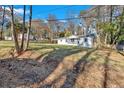 Expansive front yard showcasing a charming one-story home with white siding and mature trees at 1766 Blossom Ln, Austell, GA 30168