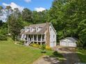Charming two-story home with inviting front porch, two car garage and lush landscaping at 1822 Morgan Rd, Canton, GA 30115