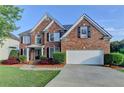 Beautiful two-story brick home with a two-car garage and well-maintained landscaping at 1943 Blue Heron Way, Lawrenceville, GA 30043