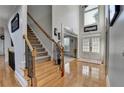 Spacious foyer features hardwood floors, staircase, and a view into adjacent rooms at 1943 Blue Heron Way, Lawrenceville, GA 30043