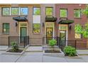 A row of brick townhomes featuring covered entries, modern black awnings, and well-maintained landscaping at 230 New St # 1303, Decatur, GA 30030
