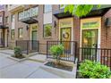 A row of three-story townhomes with brick facades, covered entries, and manicured landscaping at 230 New St # 1303, Decatur, GA 30030
