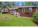 Single-Gathering home featuring a welcoming front porch and verdant lawn, perfect for outdoor enjoyment at 3492 Ember St, Marietta, GA 30066