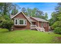 Charming single-Gathering home with a well-manicured lawn, inviting bay window and a classic, brown exterior at 3492 Ember St, Marietta, GA 30066