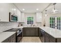 Bright, updated kitchen with modern stainless steel appliances, white and gray cabinets, and quartz countertops at 104 Verlaine Nw Pl, Atlanta, GA 30327