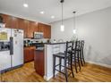 Efficient kitchen features wood cabinetry, stainless appliances, breakfast bar, and stylish pendant lighting at 238 Walker # 39, Atlanta, GA 30313