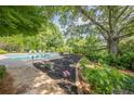 Lush backyard featuring a sparkling pool and beautifully landscaped areas for relaxation and enjoyment at 4891 Tarry Post Ln, Suwanee, GA 30024