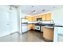 Functional kitchen featuring stainless steel appliances and light wood cabinets at 115 W Peachtree Nw Pl # 709, Atlanta, GA 30313