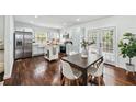 Open-concept kitchen and dining area with modern appliances, a center island, and stylish dining set at 2106 Penrose Dr, Atlanta, GA 30344