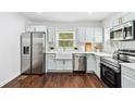 Modern kitchen featuring stainless steel appliances, light cabinets, and white countertops at 2106 Penrose Dr, Atlanta, GA 30344