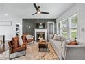 Bright living room features a fireplace, comfortable seating, modern decor, and lots of natural light at 2106 Penrose Dr, Atlanta, GA 30344