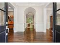 Elegant foyer with dark wood floors and arched doorways leading to other rooms at 4555 Peachtree Dunwoody Rd, Sandy Springs, GA 30342