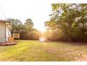 Spacious backyard featuring a shed and deck, surrounded by lush trees, offering a serene outdoor retreat at 4665 Jersey Walnut Grove Rd, Covington, GA 30014