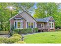Beautifully landscaped front yard of a ranch home with brick accents and a cozy entrance at 4805 Forest Way Ct, Marietta, GA 30066