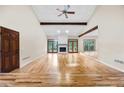 Open living room features a fireplace, wood beams, hardwood floors, and lots of natural light at 4805 Forest Way Ct, Marietta, GA 30066