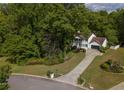 Well-maintained two-story home with lush green landscaping, a long driveway, and attached two-car garage at 731 Sacketts Ct, Lawrenceville, GA 30043