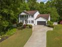 Beautiful two-story home with a manicured lawn and a long driveway that leads to a two-car garage at 731 Sacketts Ct, Lawrenceville, GA 30043