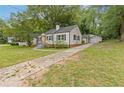 A cozy single-story house featuring a long driveway leading to a detached garage at 992 Estes Sw Dr, Atlanta, GA 30310