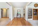 Inviting hallway with gleaming hardwood floors, neutral paint, and view to rooms in this stylish home at 1180 Chandler Ridge Dr, Lawrenceville, GA 30045