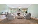Cozy living room features plush seating, fireplace, hardwood floors, and ample natural light at 1180 Chandler Ridge Se Dr, Lawrenceville, GA 30045