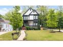 Beautiful modern home with manicured lawn, front porch, and landscaped walkway at 1676 Carroll Nw Dr, Atlanta, GA 30318