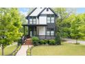 Modern home with a landscaped front yard, covered porch, and stylish curb appeal at 1676 Carroll Nw Dr, Atlanta, GA 30318