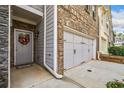 Close-up view of the front entry and garage showcasing the brick and siding details at 2142 Arnage Dr, Lithonia, GA 30058