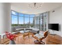 Living room features a modern lighting fixture and city view at 222 12Th Ne St # 1806, Atlanta, GA 30309