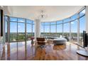 Bright living room with curved floor-to-ceiling windows and hardwood floors boasts natural light and stunning city views at 222 12Th Ne St # 1806, Atlanta, GA 30309