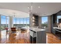 Open concept kitchen and living space featuring hardwood floors, floor-to-ceiling windows and city views at 222 12Th Ne St # 1806, Atlanta, GA 30309