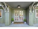 Charming entrance with double doors, light fixture, and potted plants at 1050 Mountain Creek Trl, Atlanta, GA 30328
