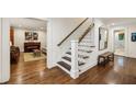Bright hallway with wooden floors, a staircase, and access to other rooms at 1050 Mountain Creek Trl, Atlanta, GA 30328