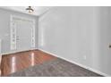 Bright entryway with hardwood floors, side-light windows and neutral walls at 110 Village Green Cir, Tyrone, GA 30290