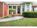 Inviting front porch with detailed columns and charming landscaping at 1510 Pecan Plantation Ct, Loganville, GA 30052