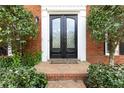 Elegant front door with diamond pane glass and manicured landscaping at 4344 White Surrey Nw Dr, Kennesaw, GA 30144