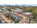 Scenic aerial view of townhouses and the city skyline nestled among lush green trees at 1199 Huff Nw Rd # 112, Atlanta, GA 30318