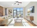 Inviting living room featuring hardwood floors, white sofa and an oversized window providing natural light at 1199 Huff Nw Rd # 112, Atlanta, GA 30318