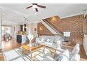 Bright living room boasts modern decor, hardwood floors, brick accent wall and open floor plan at 1199 Huff Nw Rd # 112, Atlanta, GA 30318