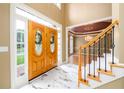 Grand foyer with marble floors, staircase and view into the formal dining room at 1430 Hampton Hill Dr, Alpharetta, GA 30022