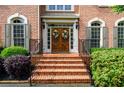 Close-up of the front entry boasting double doors and manicured greenery flanking the brick steps at 1430 Hampton Hill Dr, Alpharetta, GA 30022