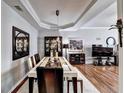Elegant dining room features tray ceiling, hardwood floors and a large formal dining set at 2695 Ridge Run Trl, Duluth, GA 30097