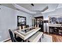Elegant dining room features tray ceiling, hardwood floors and a large formal dining set at 2695 Ridge Run Trl, Duluth, GA 30097