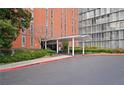 A well-maintained building exterior with a covered entrance and manicured landscaping at 3060 Pharr Court N N Ct # 607, Atlanta, GA 30305