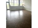 Bright living room featuring parquet flooring, large windows offering lots of natural light and a door to the balcony at 3060 Pharr N Ct # 607, Atlanta, GA 30305