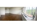 Spacious living room featuring parquet flooring, large windows offering lots of natural light, and neutral wall color at 3060 Pharr N Ct # 607, Atlanta, GA 30305