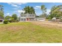 Charming two-story home with a bright red front door and covered porch at 565 Deer Sw Run, Lilburn, GA 30047