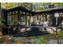 View of the outdoor deck area with black painted stairs leading to the backyard at 922 Barton Woods Ne Rd, Atlanta, GA 30307