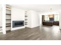 Open-concept living room that flows into the kitchen with stylish flooring at 11554 Serenbe Ln, Chattahoochee Hills, GA 30268