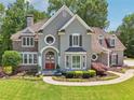 Stunning two-story home with lush landscaping, gray stucco and stone accents on a verdant lot at 2645 Preston Ridge Ln, Dacula, GA 30019