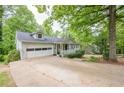 Exterior view of home with a long driveway and well-maintained lawn at 2663 Marcia Dr, Lawrenceville, GA 30044
